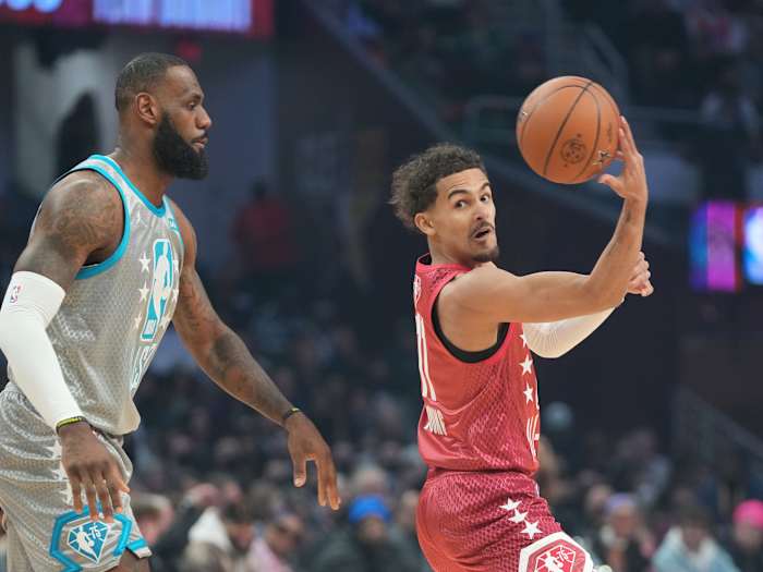 Trae Young passes the ball away from LeBron James in the 2022 NBA All-Star Game.